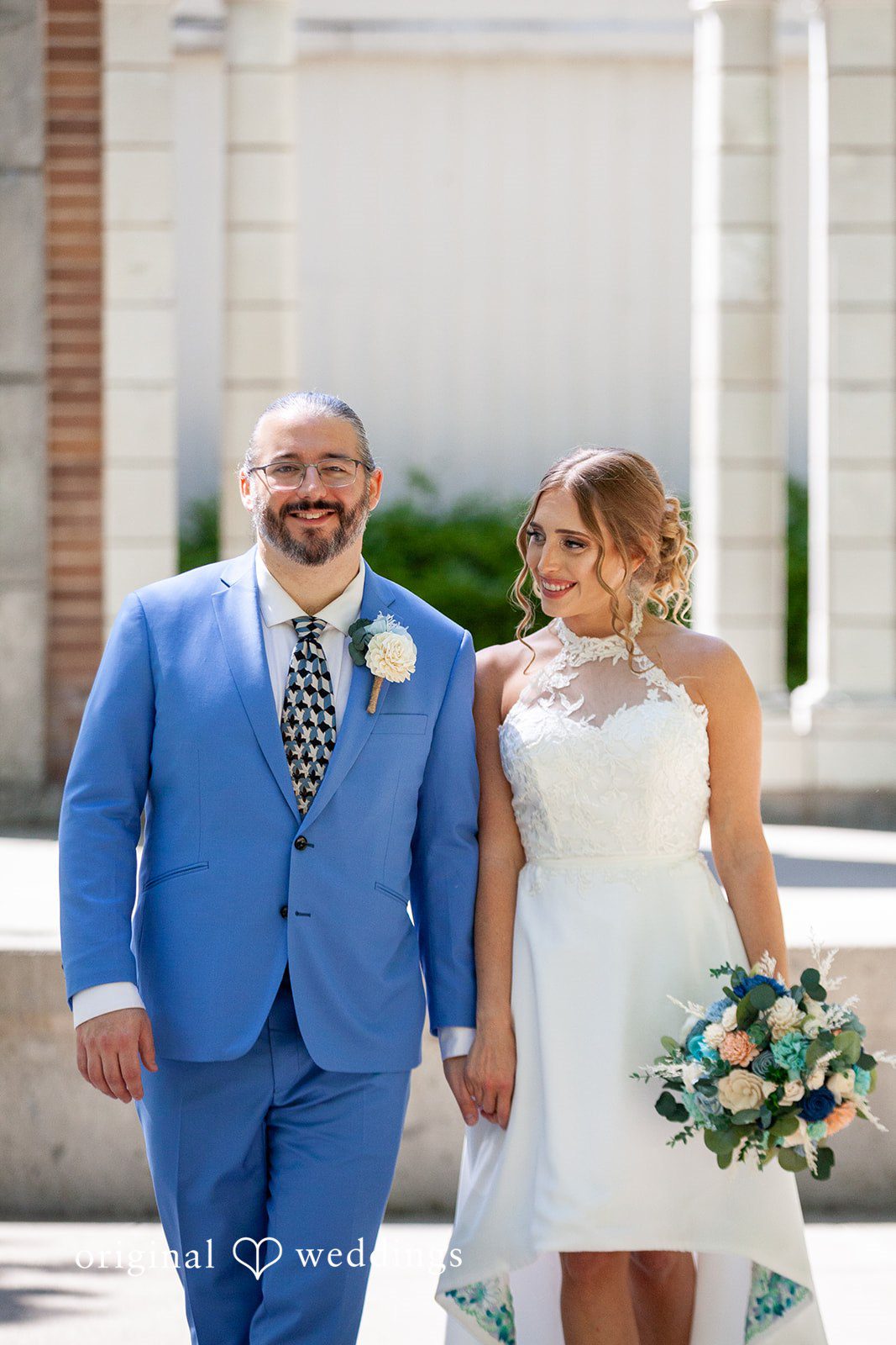 Sasha + Tom Couple holding hands during portrait session at The Great Hall at Green Lake