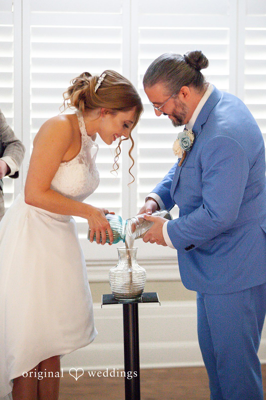 Sasha + Tom Couple pouring champagne at The Great Hall at Green Lake
