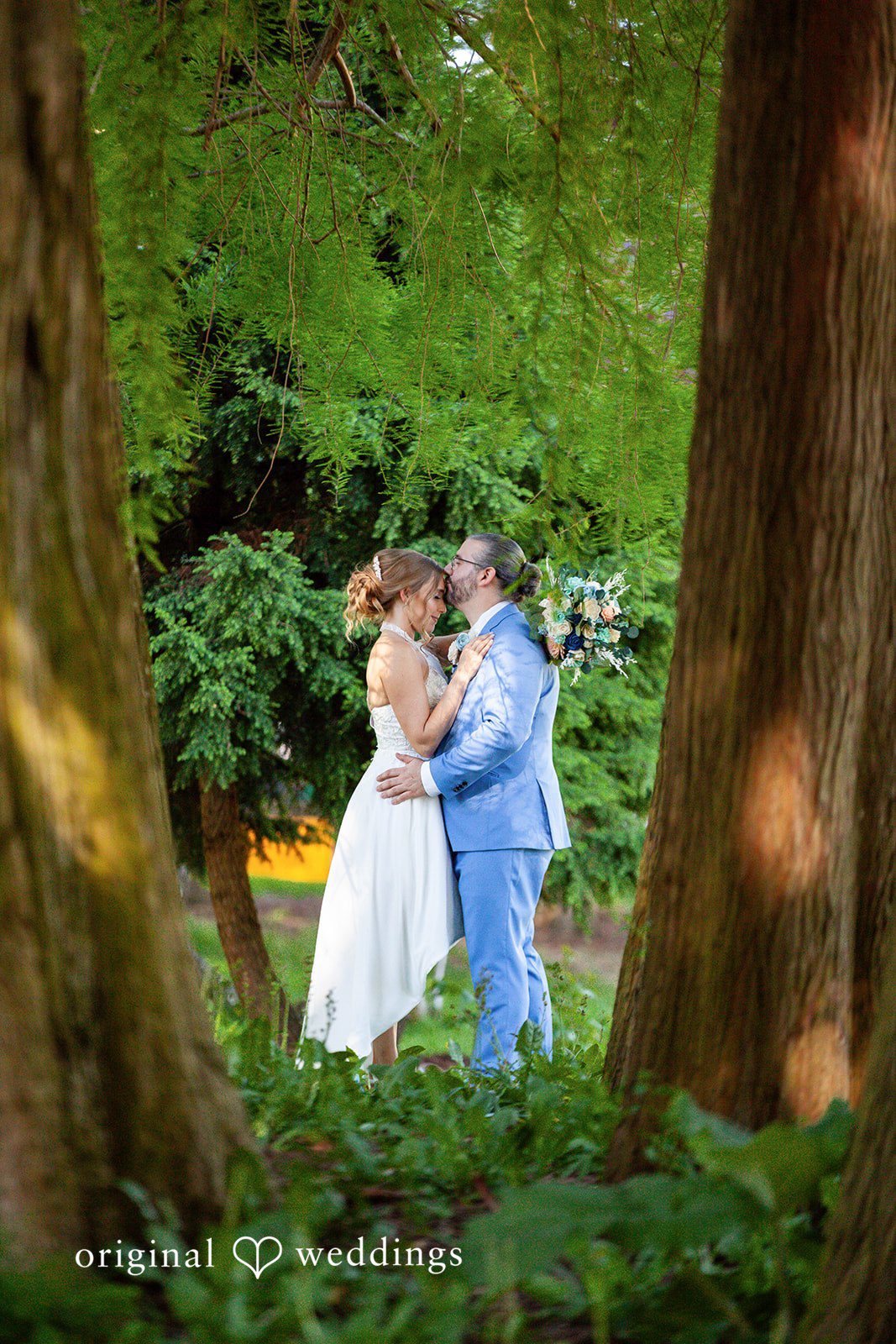 Sasha + Tom Groom kissing bride's forehead at The Great Hall at Green Lake