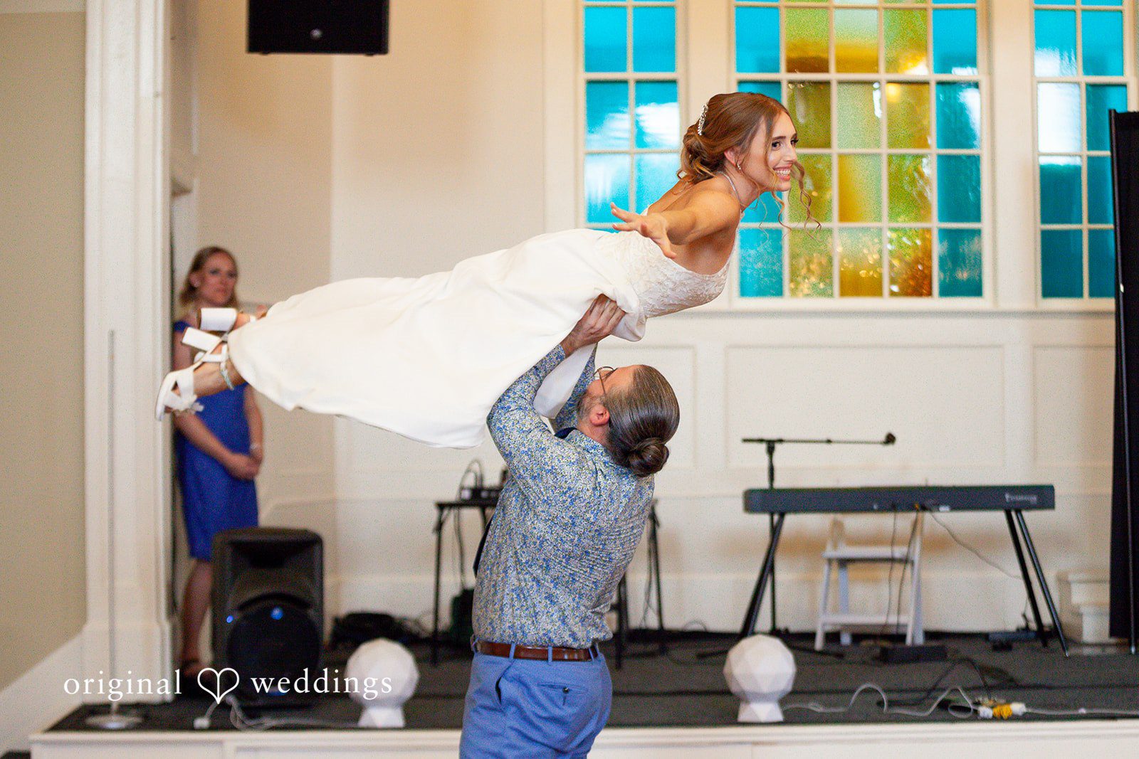 Sasha + Tom Groom lifting bride during reception at The Great Hall at Green Lake
