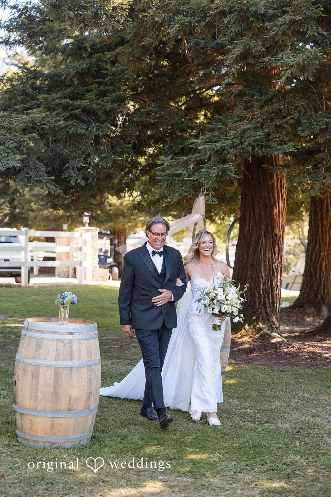 Avery + Ryan A bride walking down the grassy aisle arm-in-arm with a man.