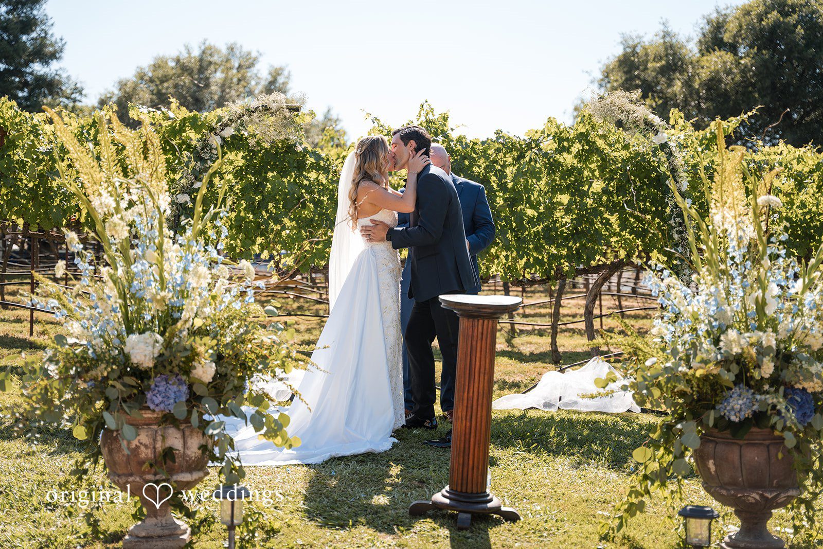 Avery + Ryan A bride and groom sharing their first kiss at the altar.