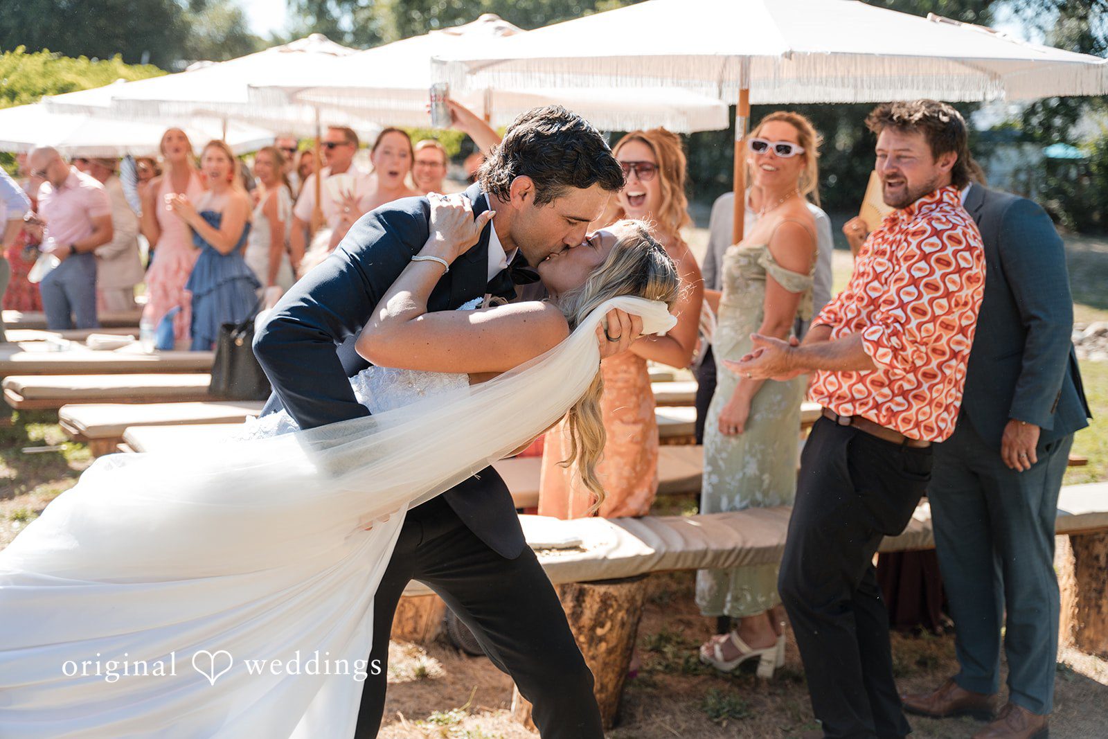 Avery + Ryan A groom enthusiastically dipping his bride during their recessional walk.
