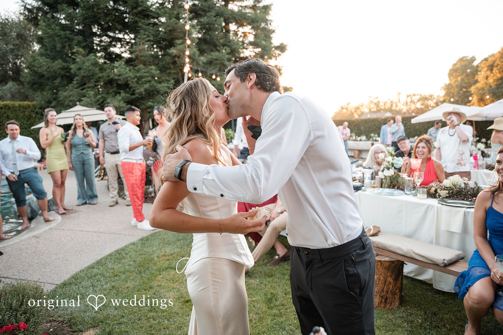 Avery + Ryan A bride and groom sharing a kiss on dance floor during their reception.