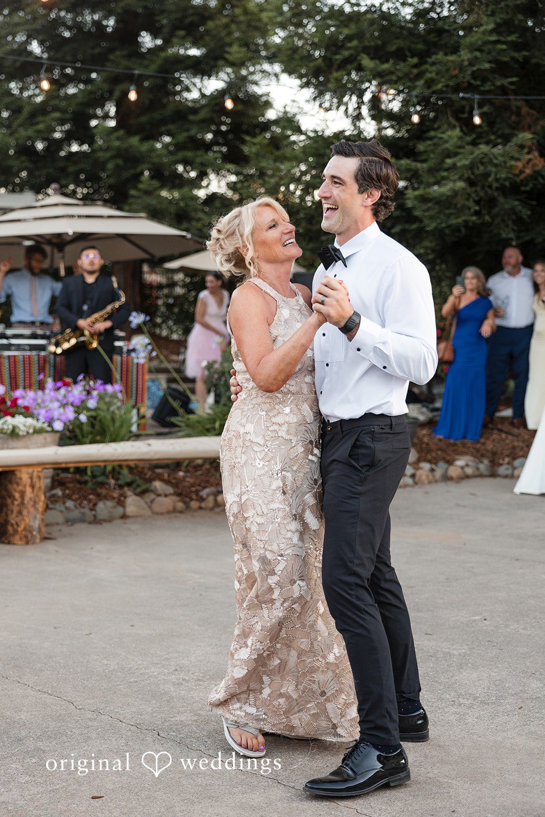 Avery + Ryan A groom dancing with a woman in a patterned dress at The Loder Estate.