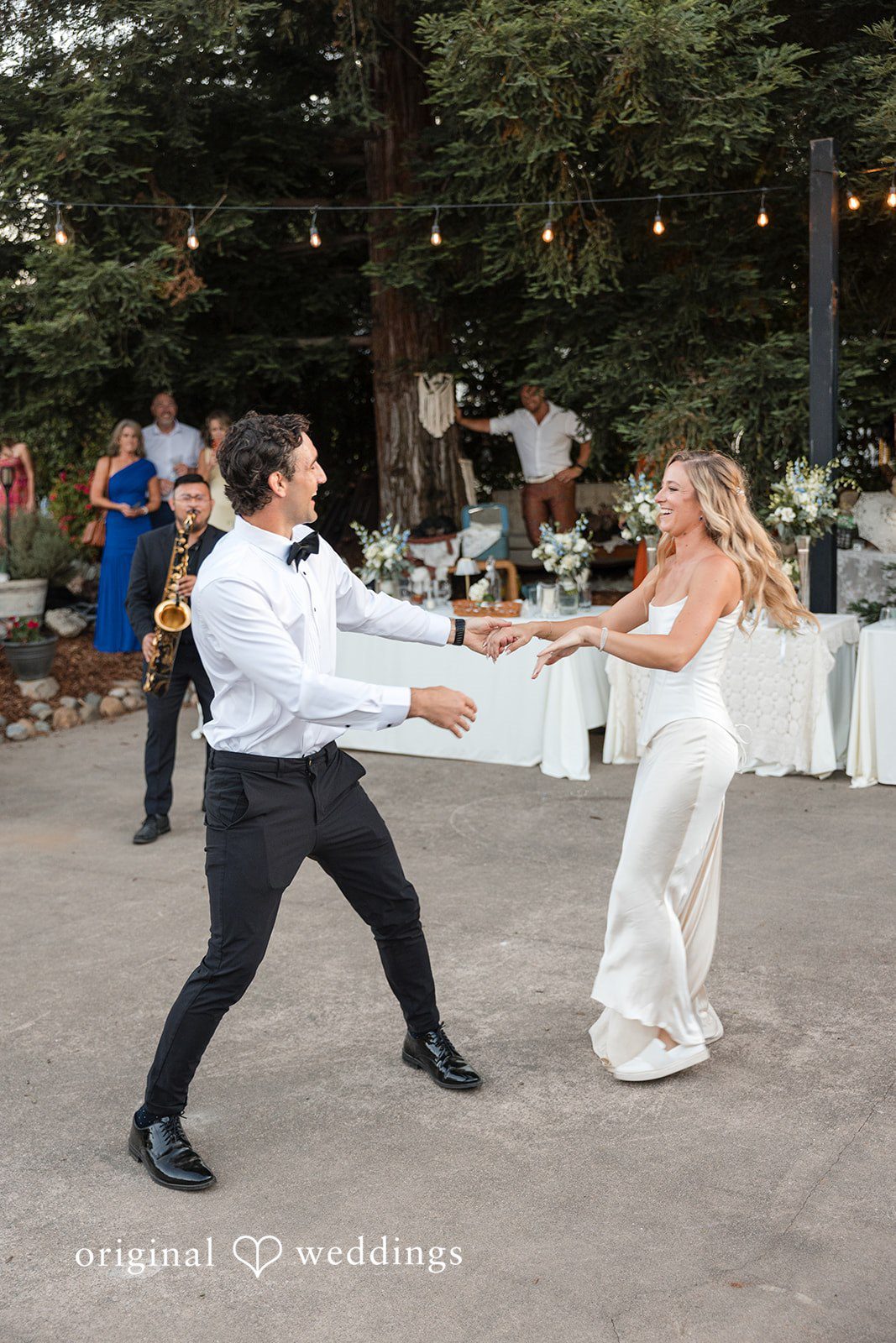 Avery + Ryan A bride and groom dancing dynamically across an open-air reception floor.