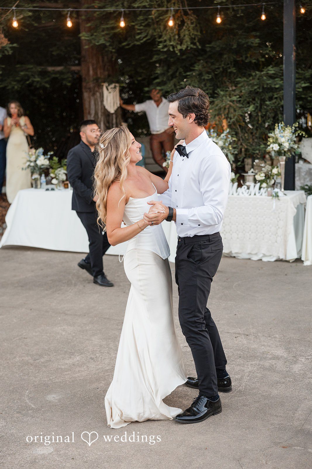 Avery + Ryan A bride and groom sharing a romantic slow dance under string lights.