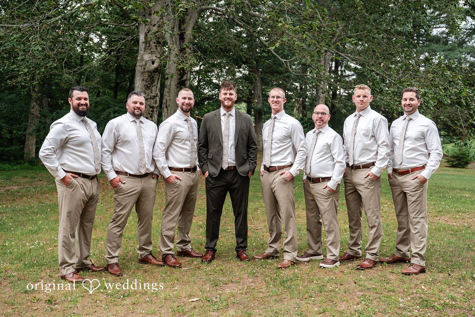 Groom smiling with groomsmen before the wedding ceremony