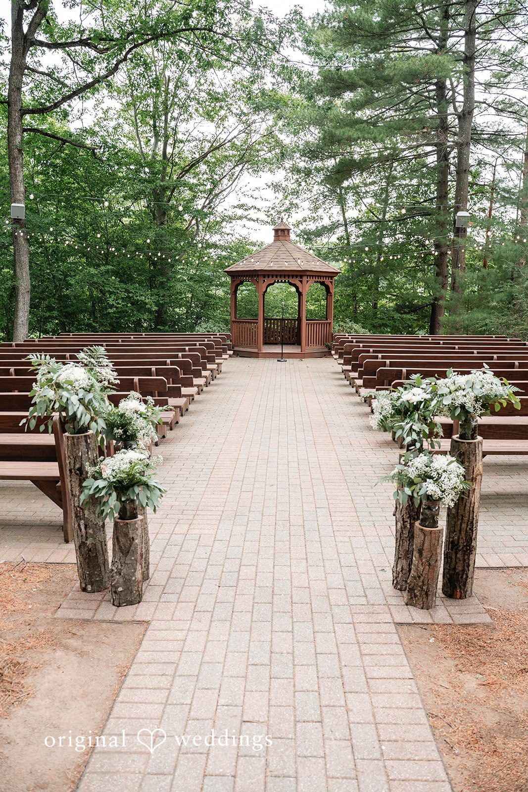 Elegant ceremony venue beautifully decorated with floral arrangements and stylish seating at The Pavilion on Crystal Lake.