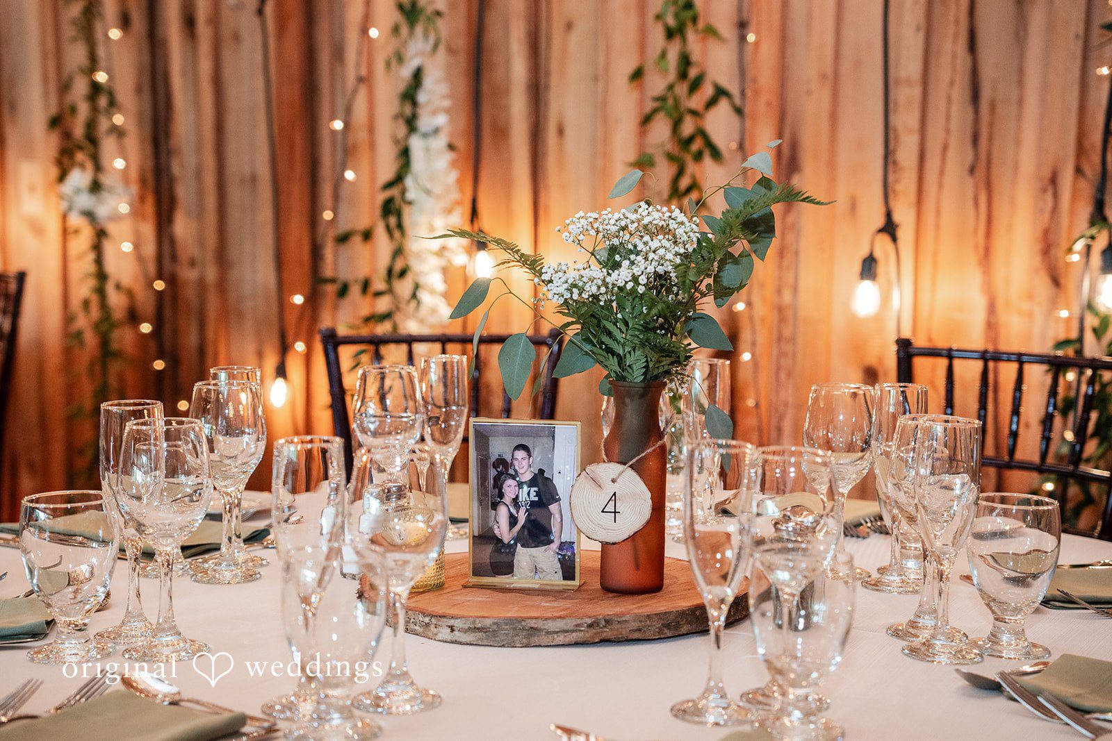 Beautifully styled reception table with glassware, greenery and romantic wedding décor.