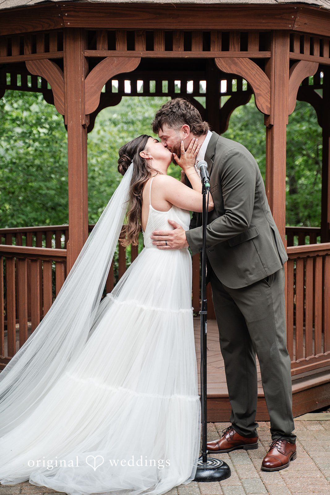 Bride and groom sharing a heartfelt kiss after ceremony