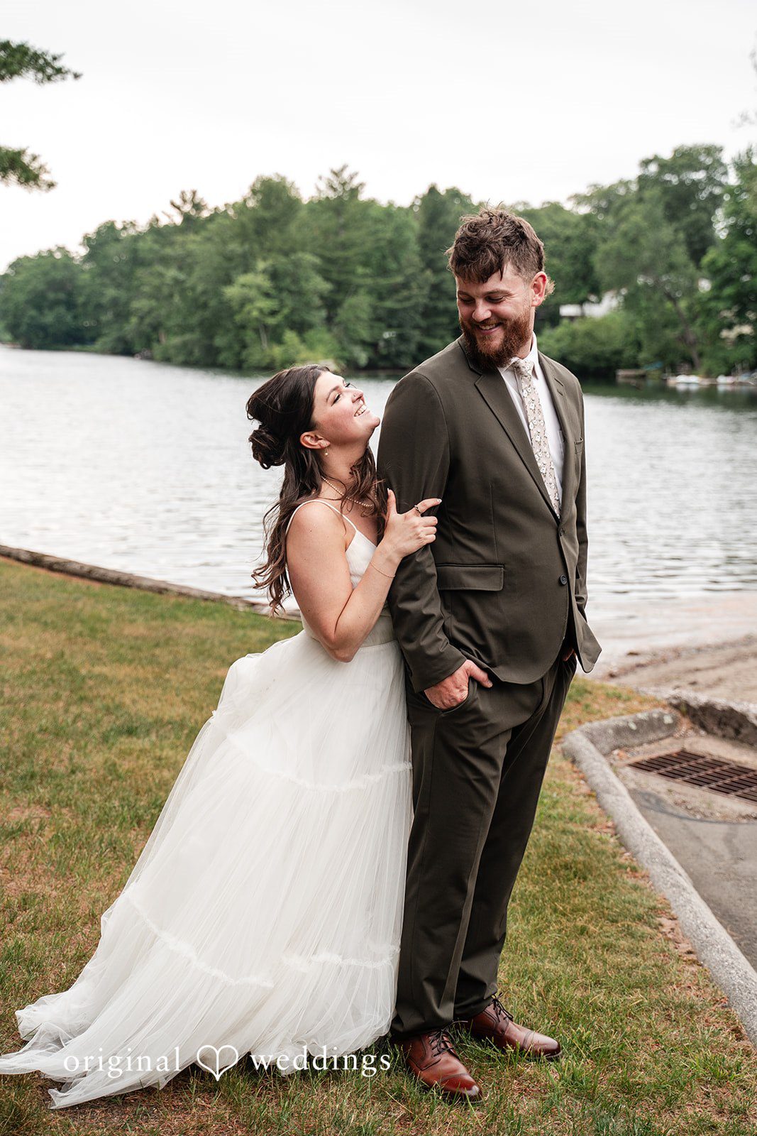 Bride and groom standing outside The Pavilion on Crystal Lake