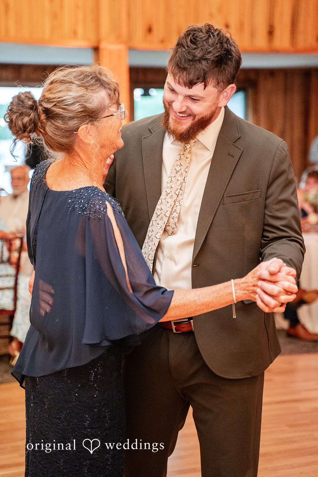 Joyful reception moment featuring the groom celebrating on the dance floor