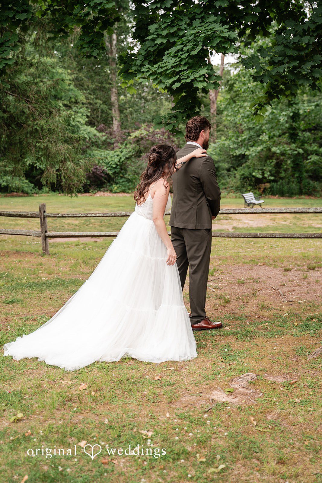 Emotional first look moment as the bride reaches the groom from behind