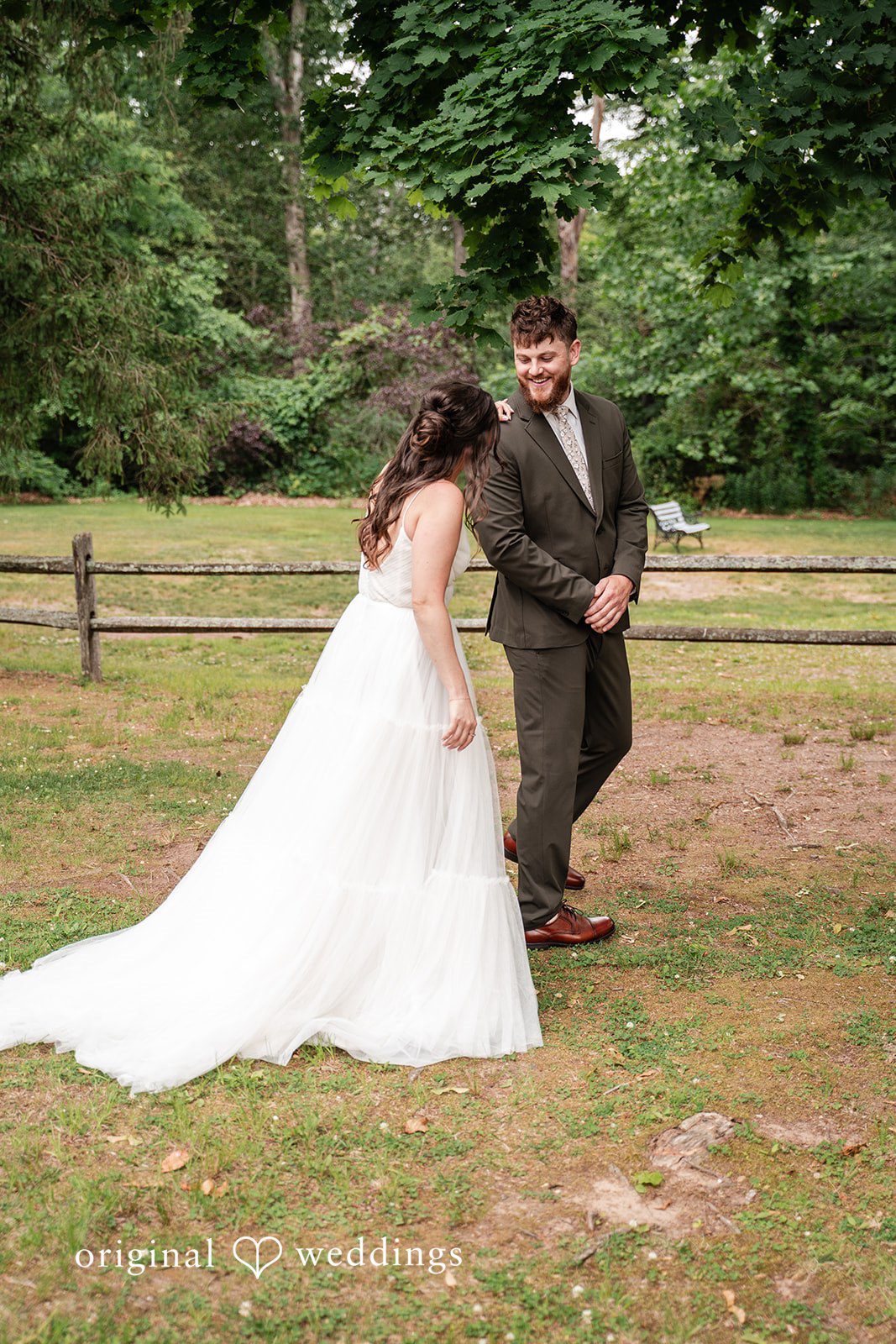 Bride gently approaching the groom at The Pavilion on Crystal Lake