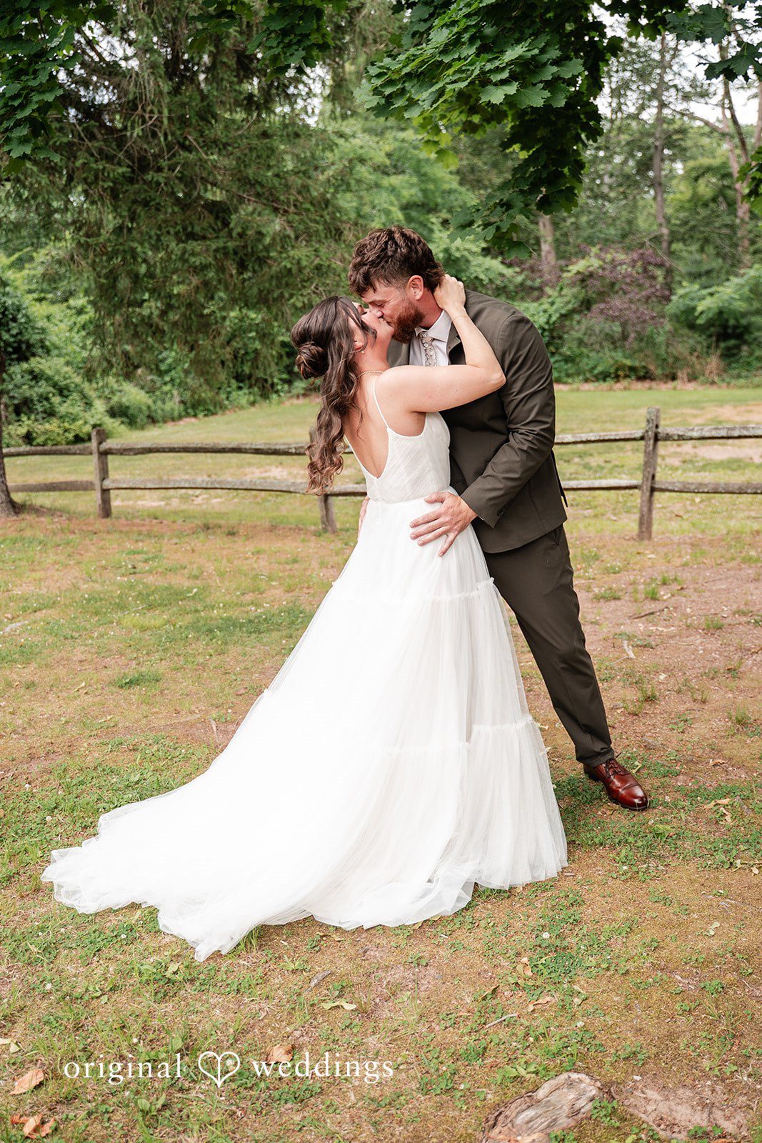 Bride and groom sharing a romantic kiss at The Pavilion on Crystal Lake