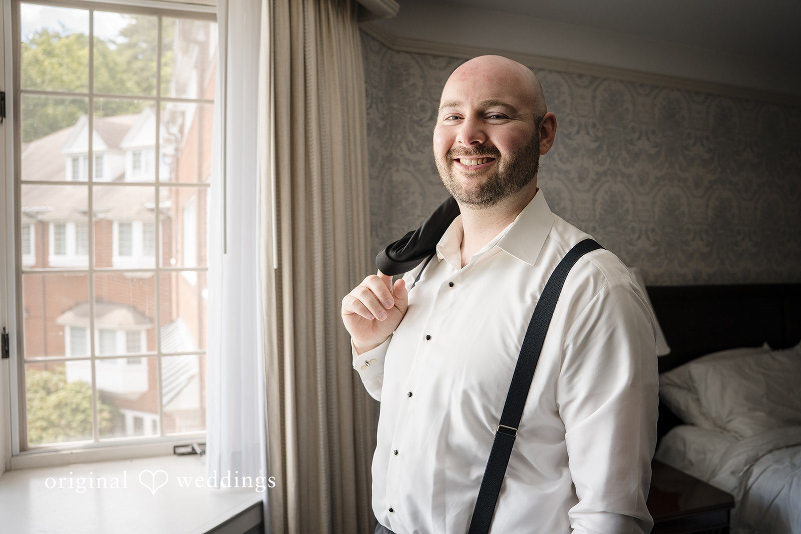 Kimberly + Jordan Groom smiling while preparing for his wedding day