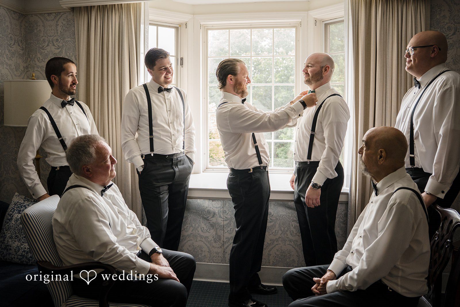 Kimberly + Jordan Groom and groomsman getting ready together inside The Riverview