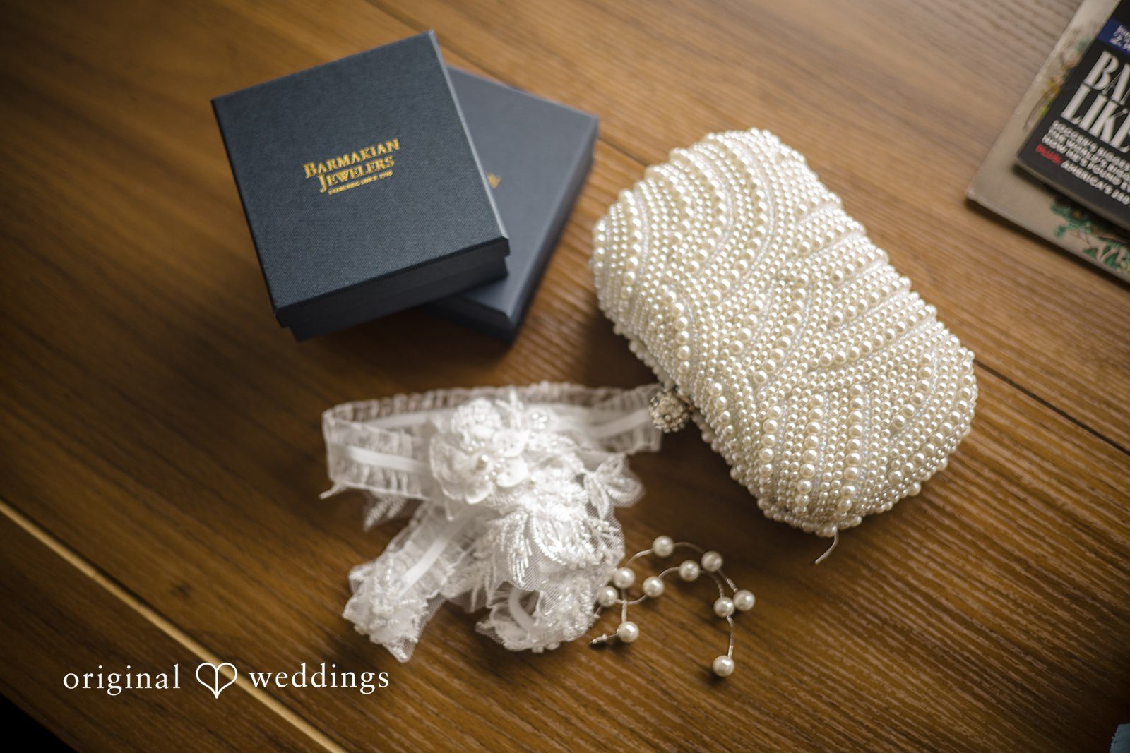 Kimberly + Jordan Elegant bridal clutch, lace garter, earrings, and jewelry displayed at The Riverview