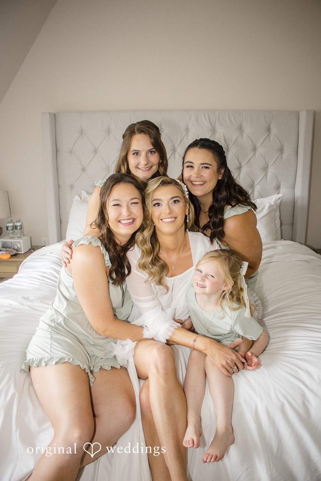 Kimberly + Jordan Bride smiling with her bridesmaids and baby girl