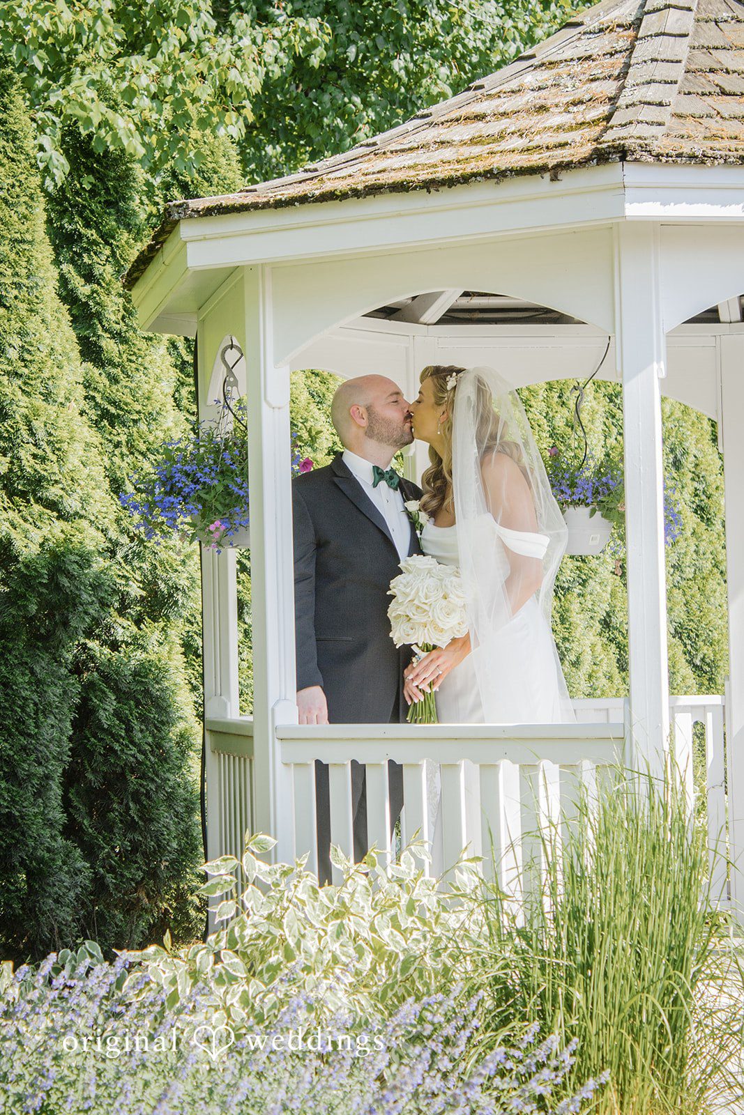 Kimberly + Jordan Romantic moment of bride and groom kiss at The Riverview