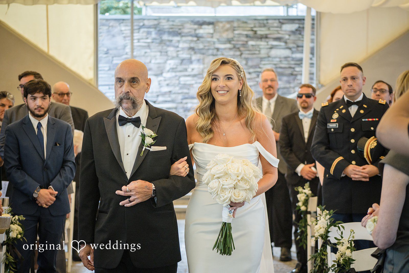 Kimberly + Jordan Bride walking down the aisle at The Riverview