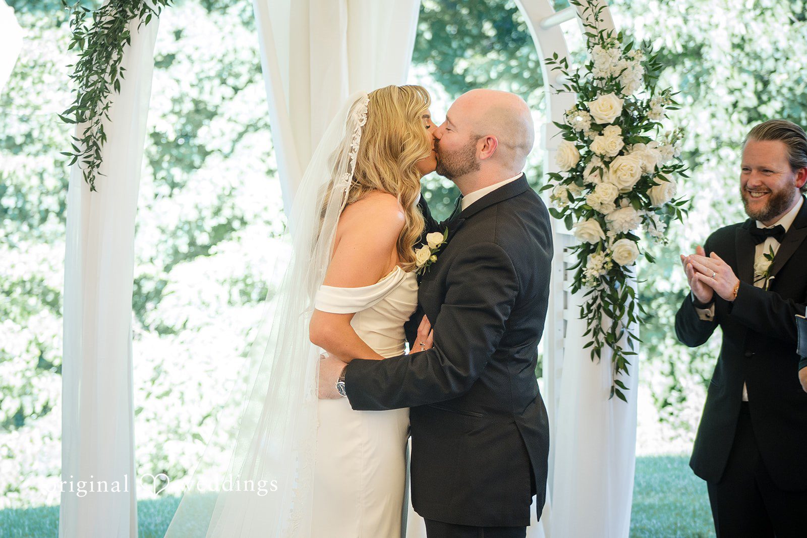 Kimberly + Jordan Romantic moment of bride and groom kissing after the ceremony