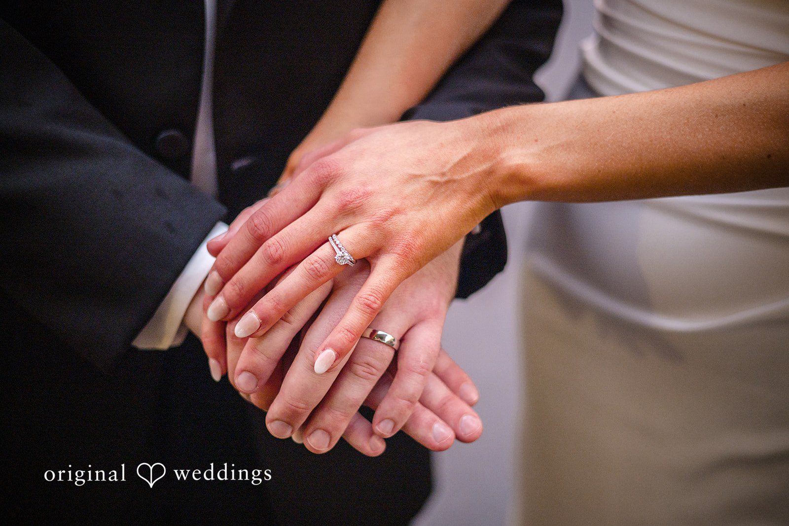 Kimberly + Jordan Bride and groom showing their wedding rings at The Riverview