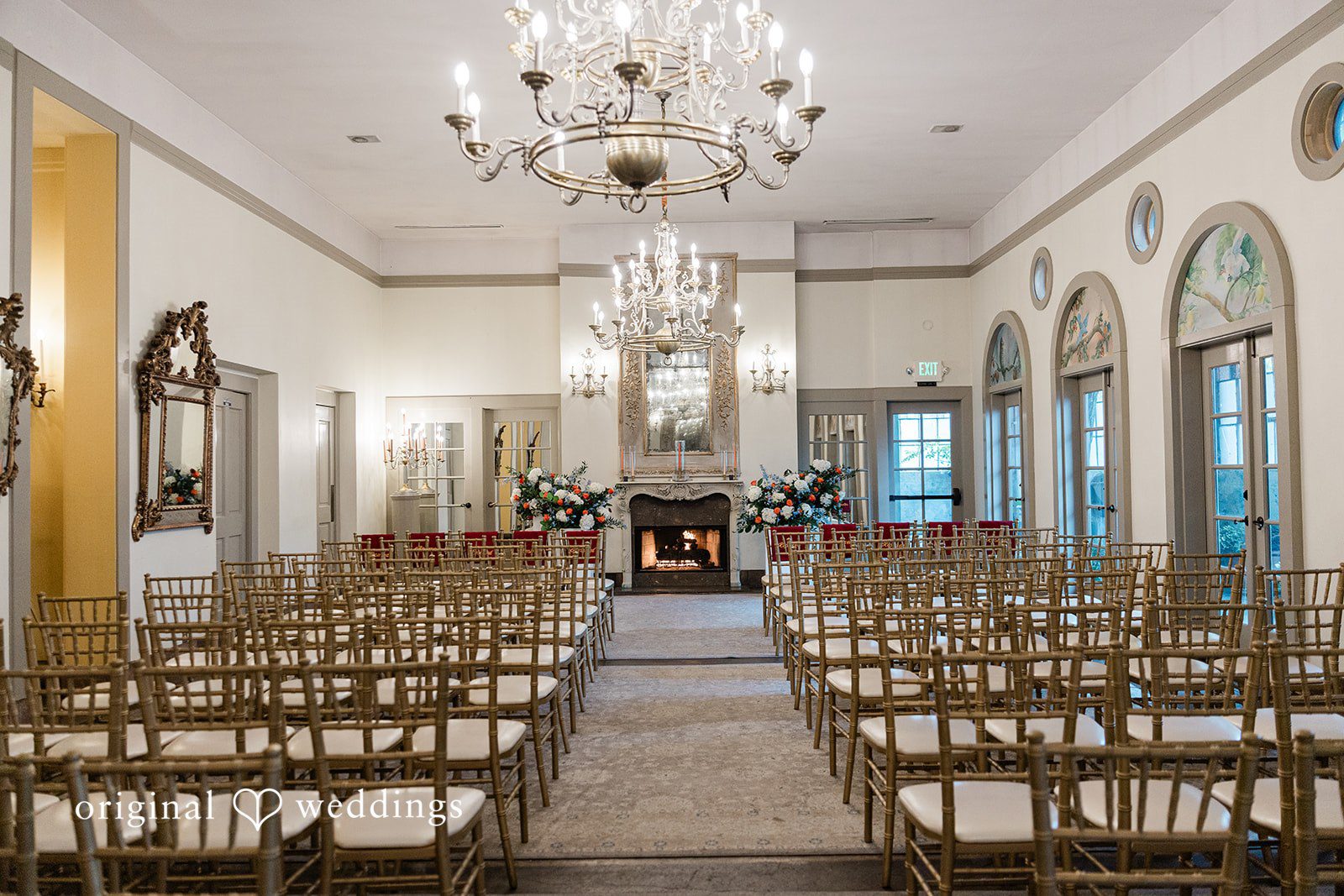 Madison + Malik An empty ceremony room with rows of wooden chairs facing a bright window.