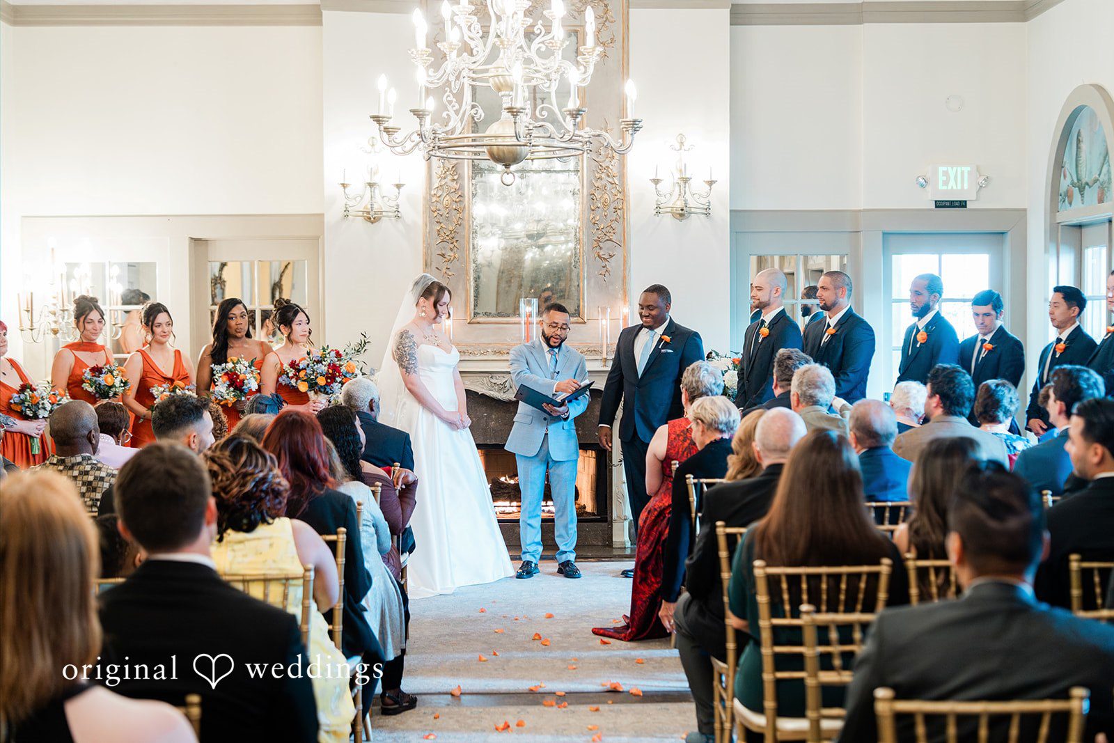 Madison + Malik A wide view of guests seated in a ceremony room facing forward.