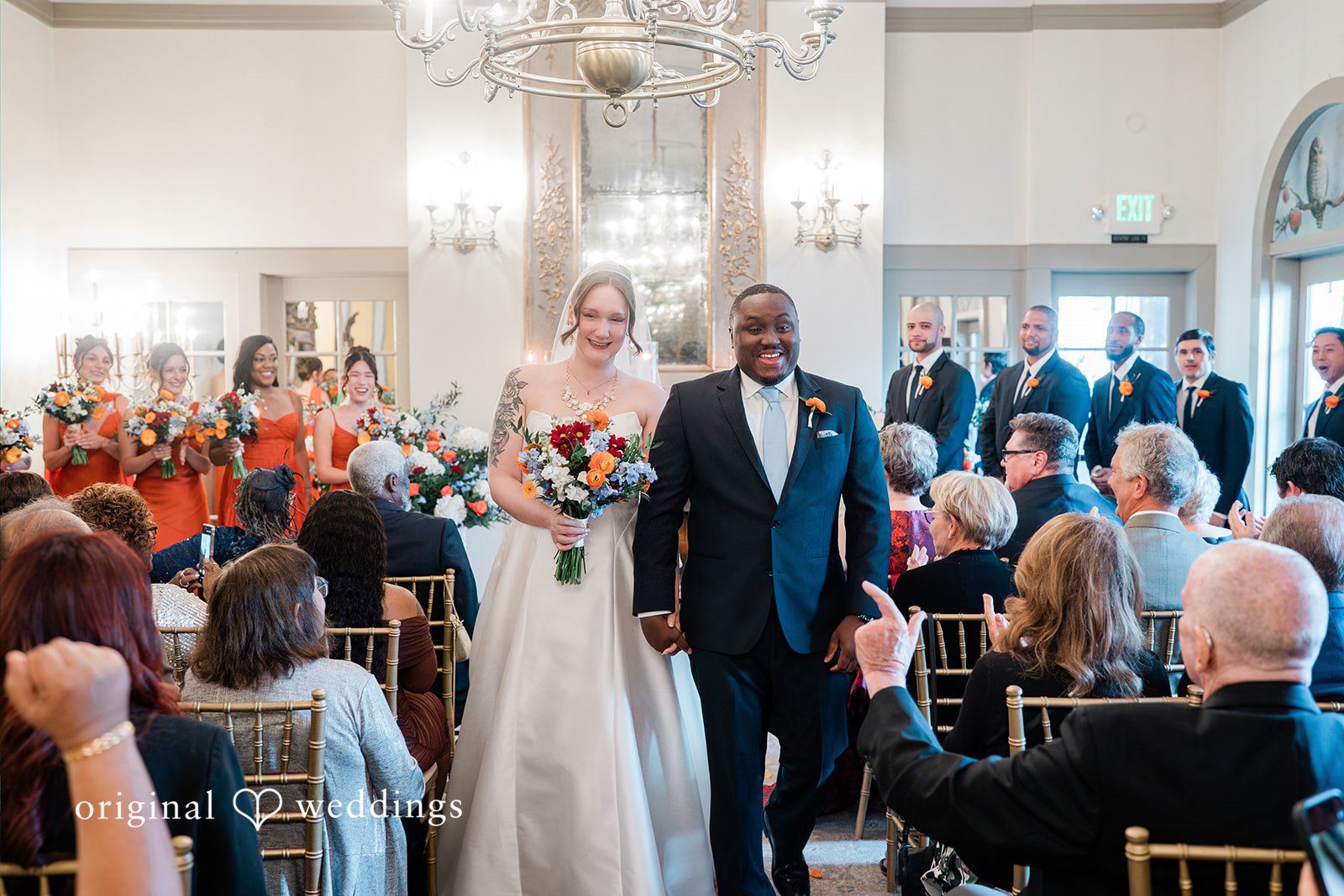 Madison + Malik Bride and groom walking down the aisle together after a ceremony.