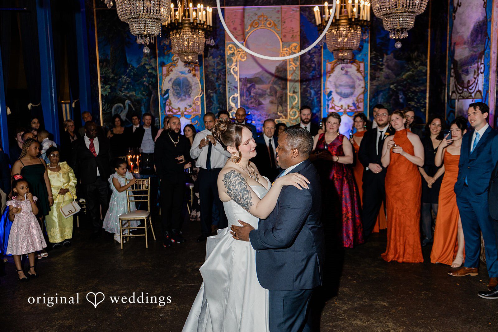 Madison + Malik A couple sharing a dance on a crowded reception dance floor.