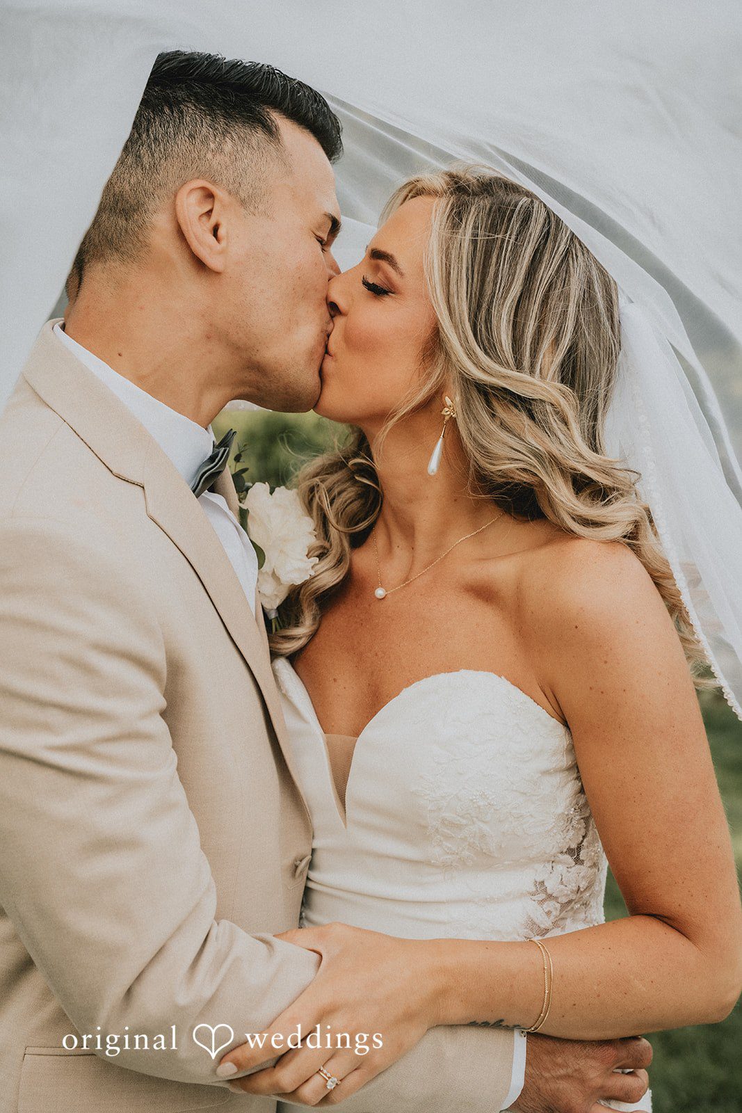 Kaylee + Raul A bride and groom sharing a romantic kiss at The Sagamore.
