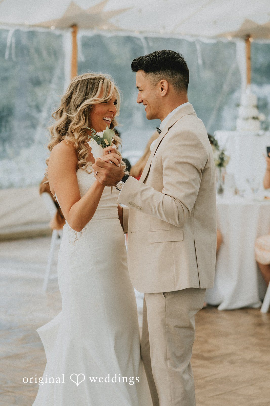 Kaylee + Raul A newlywed couple holding hands and dancing together.