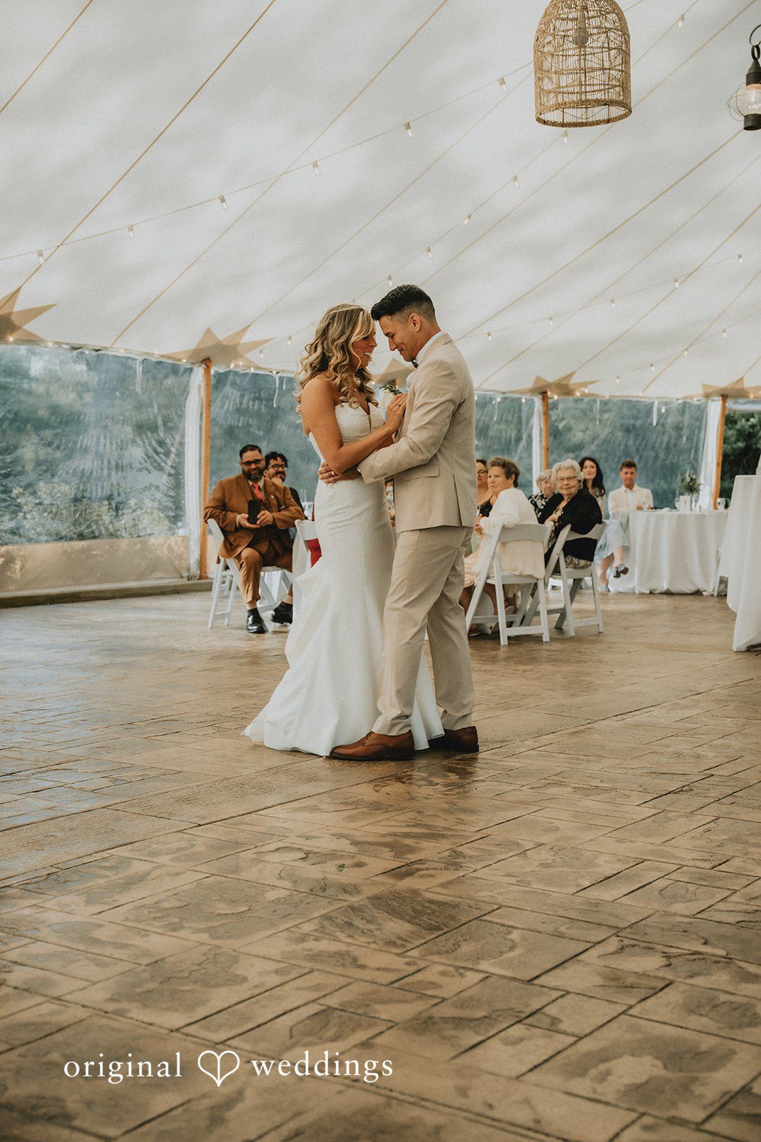 Kaylee + Raul A bride and groom sharing a dance on a wooden dance floor.