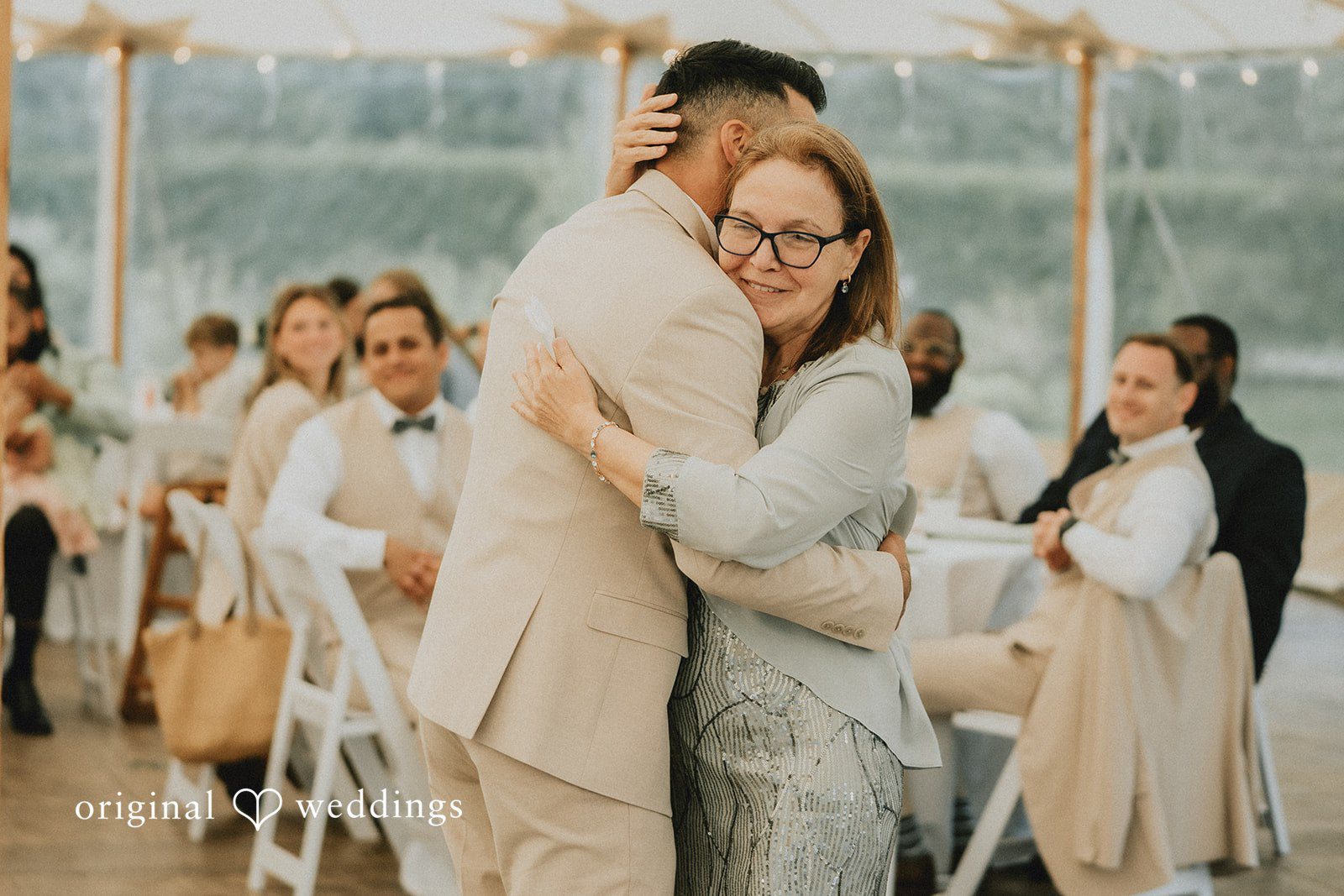 Kaylee + Raul A groom sharing a dance with a guest at the reception.