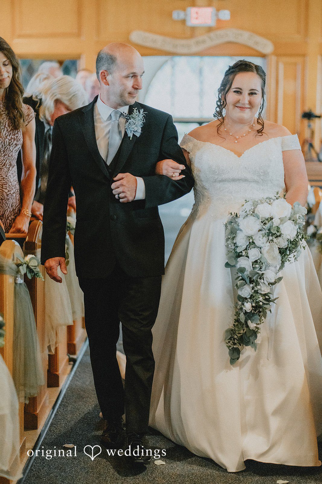 Kevin + Brooke Bride walking down the aisle with someone, arms in arms