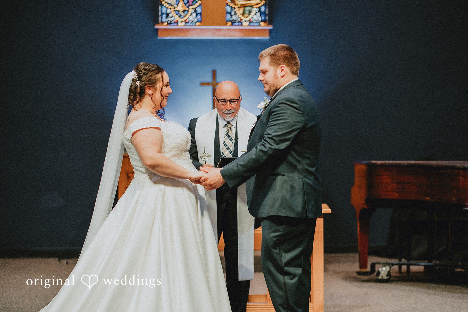 Kevin + Brooke Couple holding hands and exchanging vows during wedding ceremony at The Seville captured by Chicago wedding photographers from Original Weddings