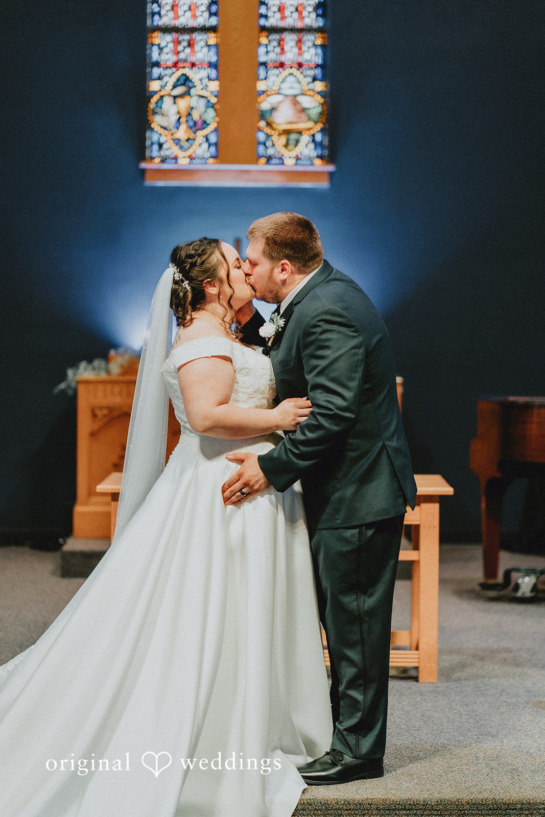 Kevin + Brooke Bride and groom sharing their first kiss during wedding ceremony at The Seville