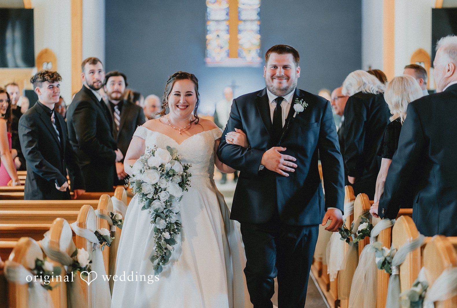 Couple leaving the altar happily at The Seville captured by Chicago wedding photographers from Original Weddings