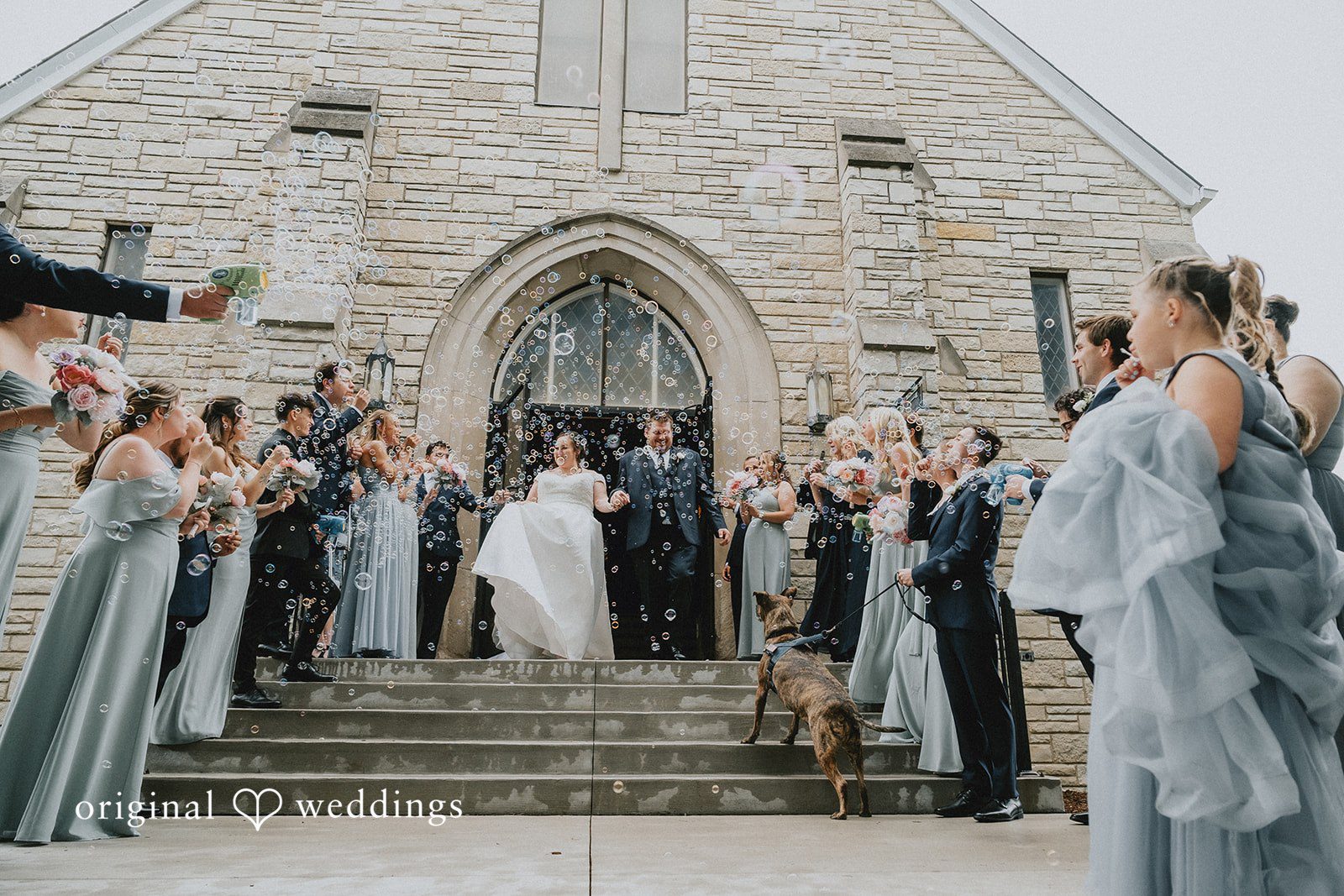 Kevin + Brooke Bride and groom leaving the hall, hands in hands and guests cheering around