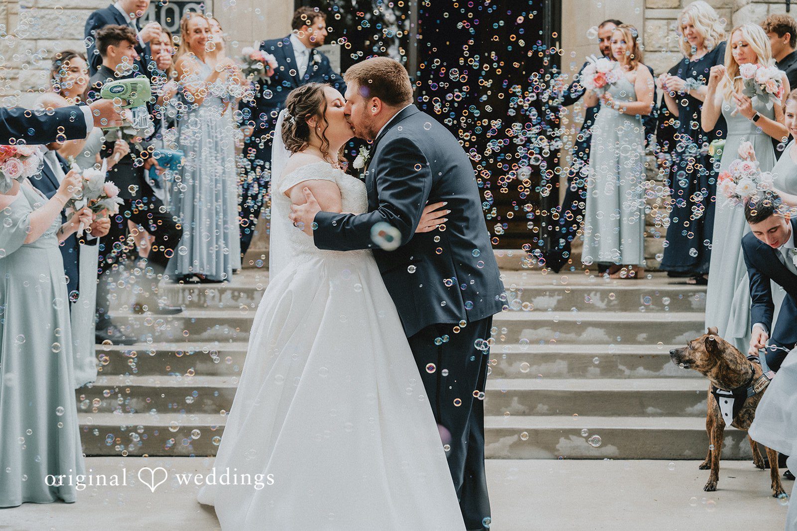 Kevin + Brooke Bride and groom sharing a romantic kiss in bubbles all around