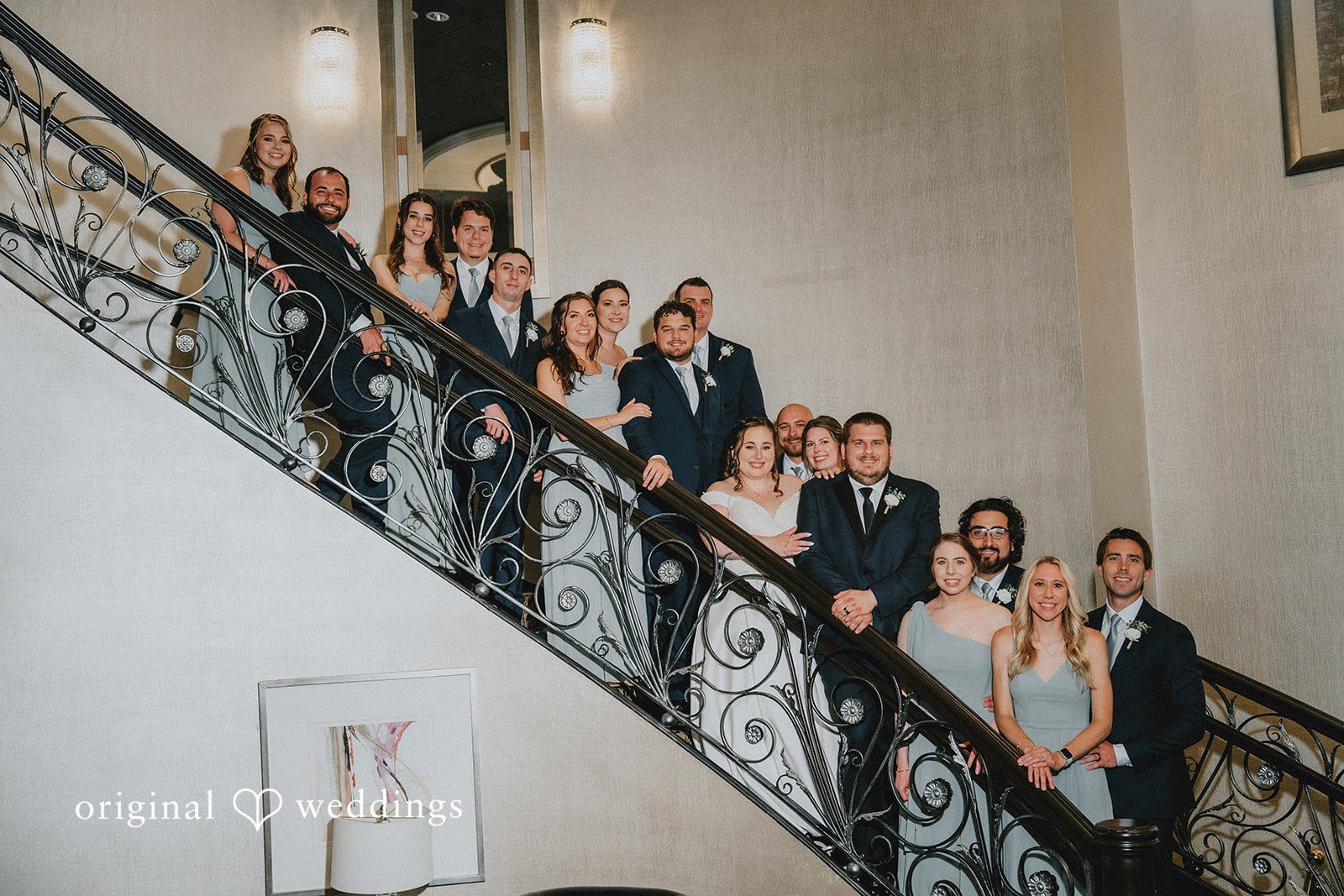 Kevin + Brooke Lovely picture of bride and groom with bridesmaids and groomsmen, all standing in stairs at The Seville