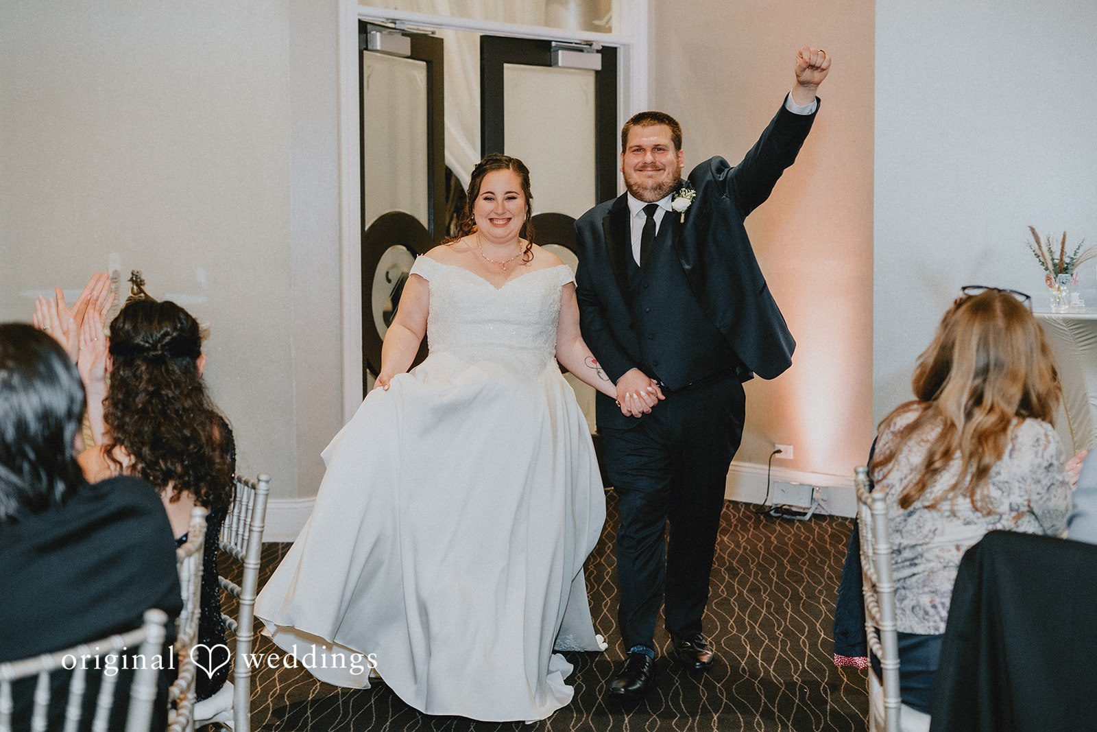 Kevin + Brooke Bride and groom expressing their happiness while entering the reception hall