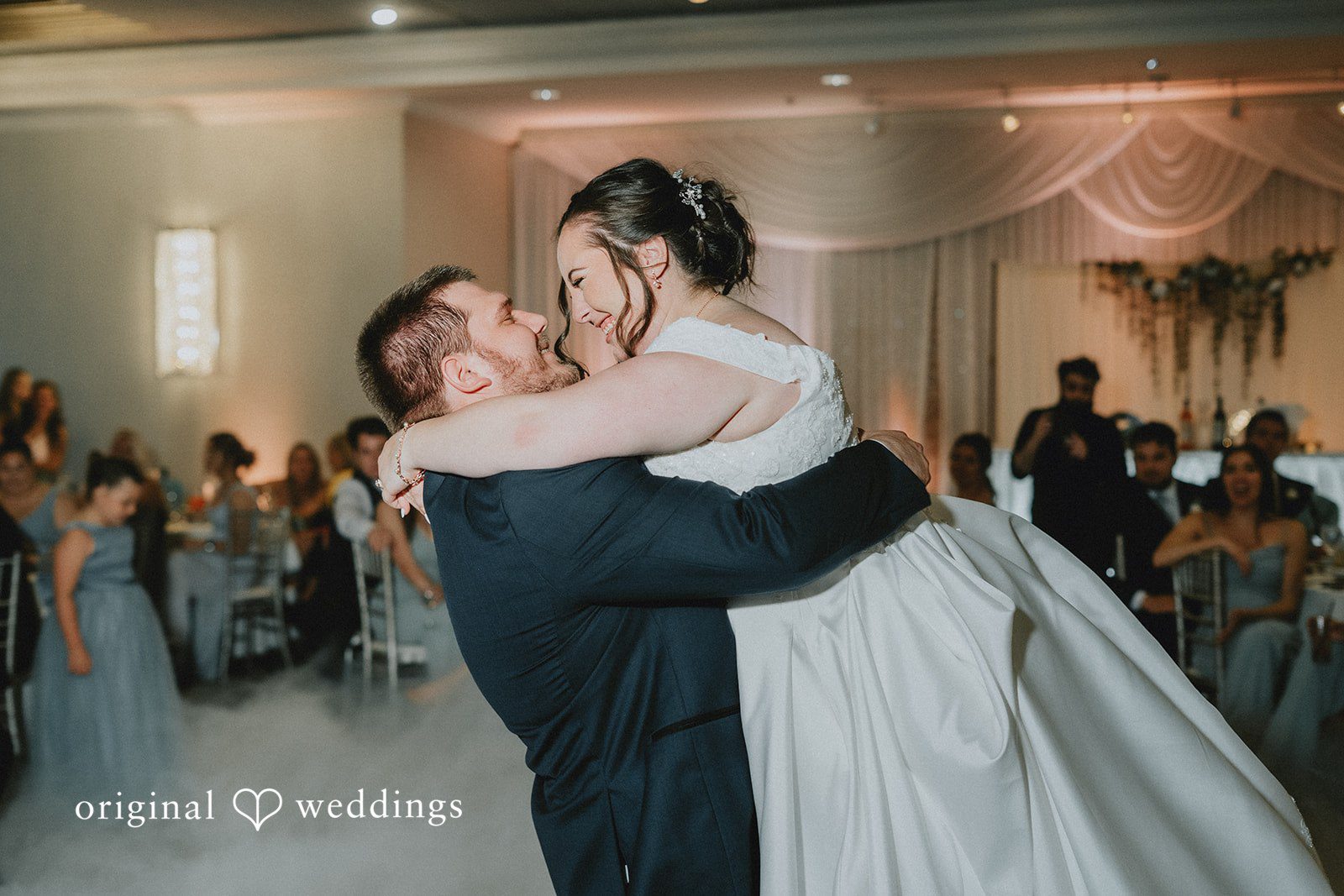 Kevin + Brooke Groom lifting up the bride while dancing