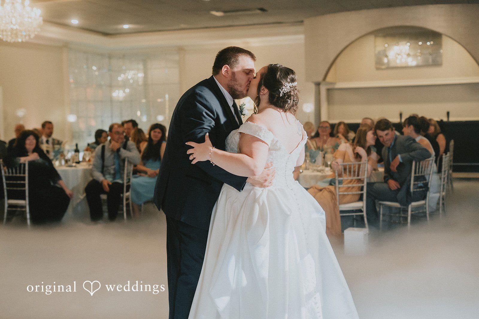 Kevin + Brooke Couple sharing a kiss while dancing during wedding reception