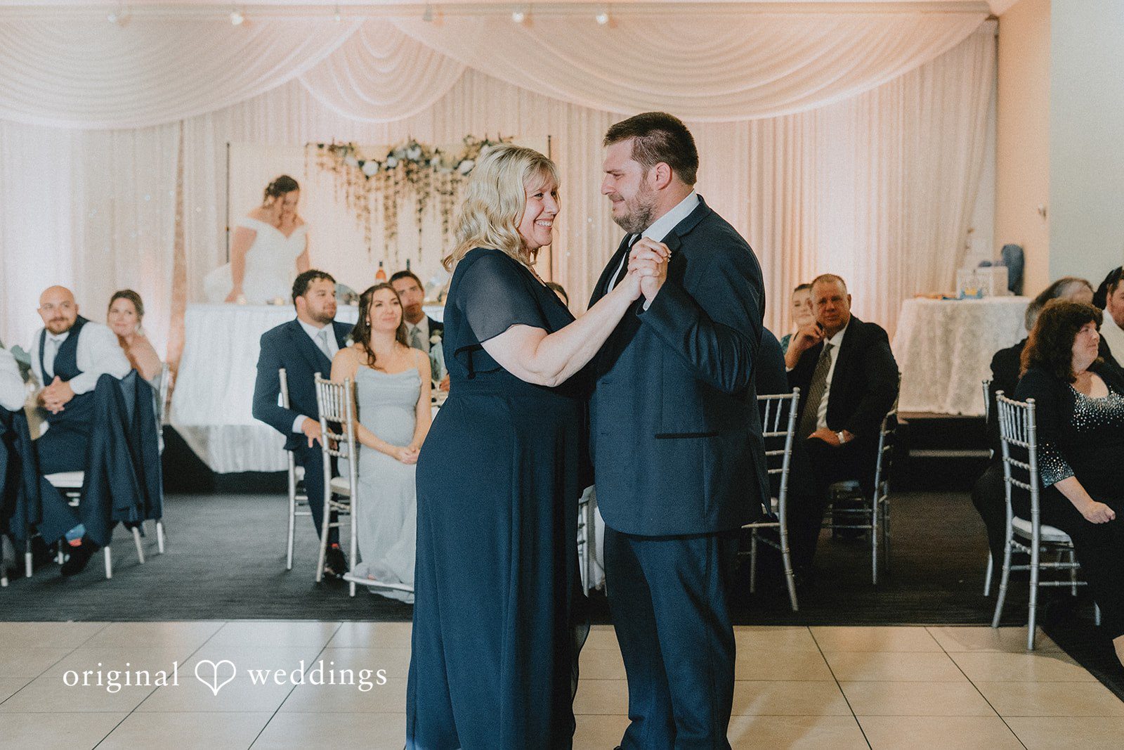 Kevin + Brooke Groom sharing a dance with someone at The Seville