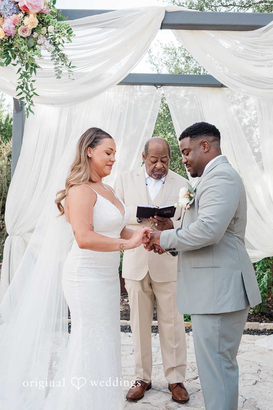 Lilly + Cade Bride and groom exchanging rings during the ceremony at The Terrace Club.