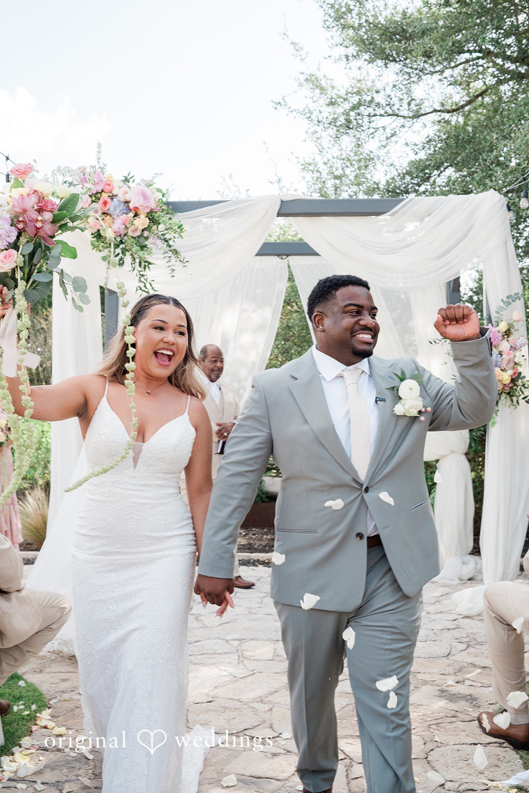 Lilly + Cade Couple walking outside after the ceremony at The Terrace Club captured by Austin Wedding Photographers from Original Weddings.