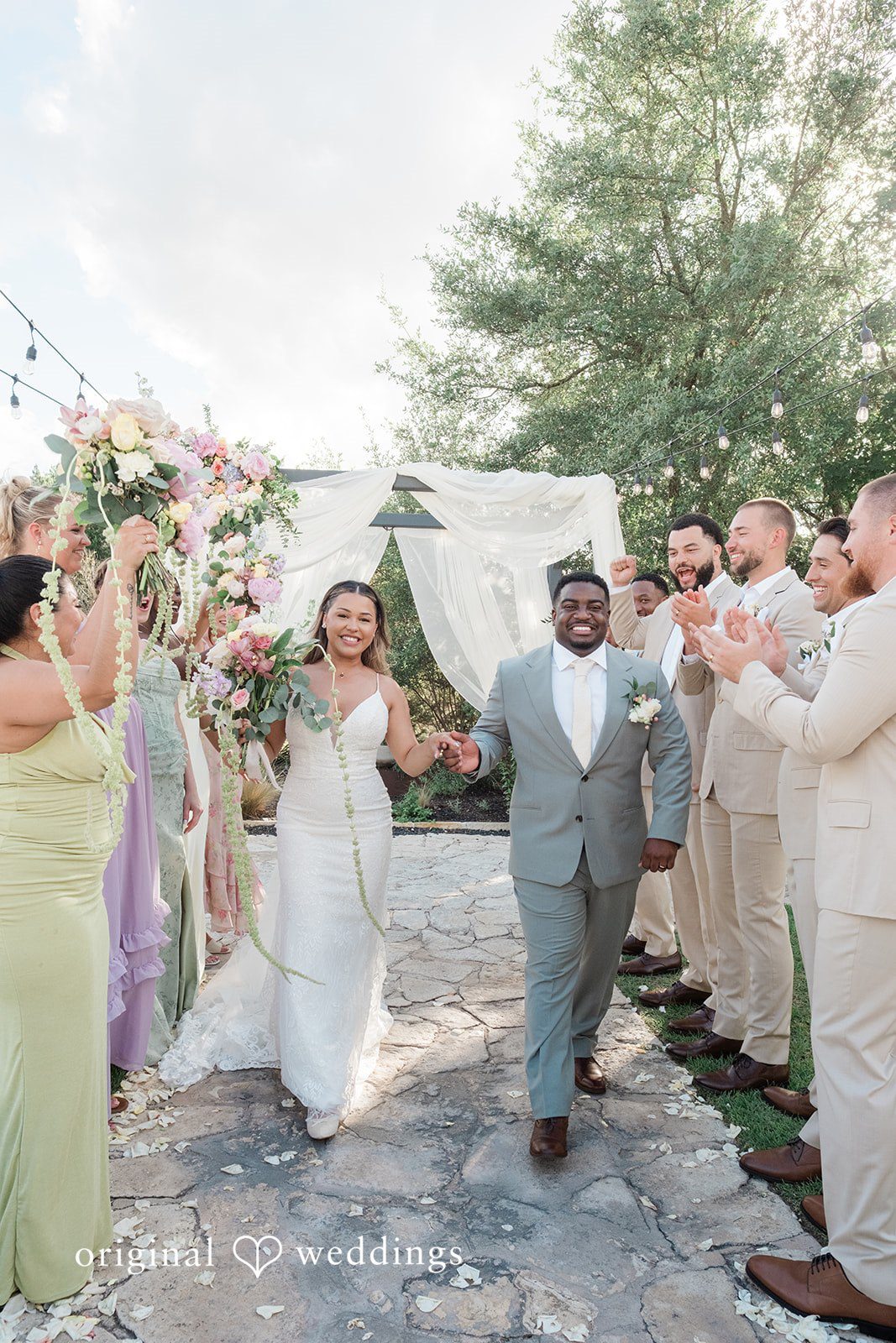 Lilly + Cade Bride and groom walking together after their wedding ceremony at The Terrace Club.